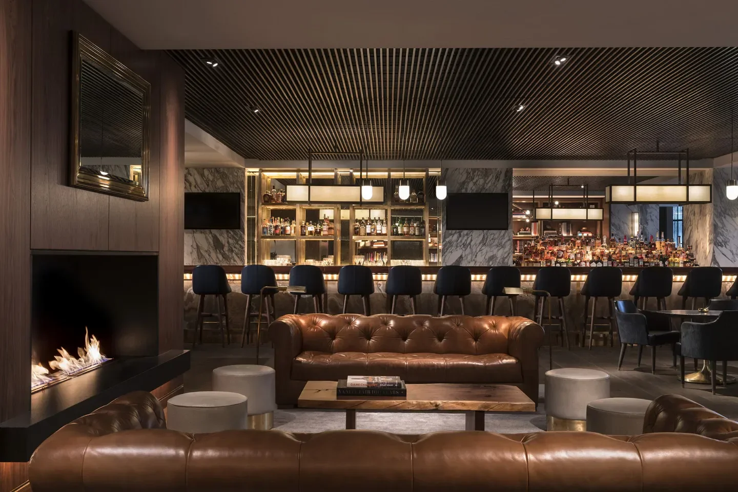 Cozy interior of Bayou & Bottle in Houston, featuring a leather sofa and bar.