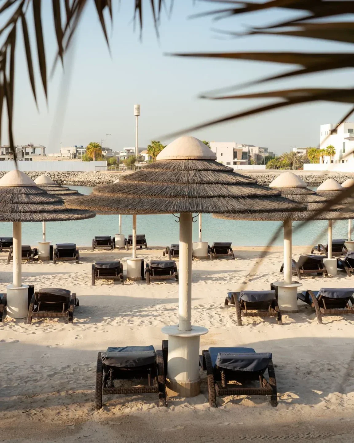 Bayshore Beach Club Abu Dhabi with beach umbrellas and lounge chairs, Abu Dhabi.
