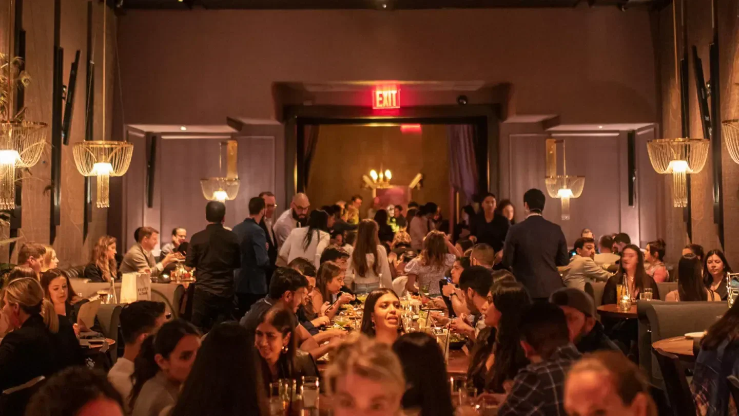 Busy dining room at Beauty & Essex in New York City with people enjoying dinner.