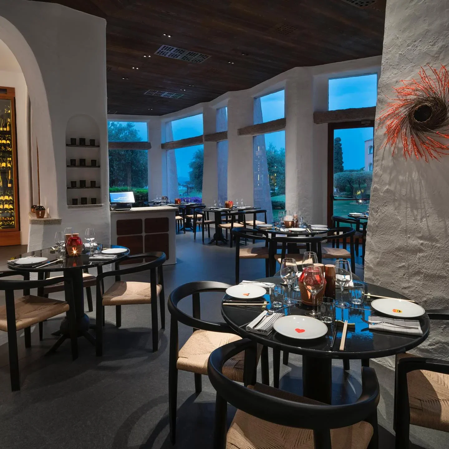 Stylish dining room at Beefbar Cala di Volpe in Porto Cervo with ambient lighting and garden view of gardens