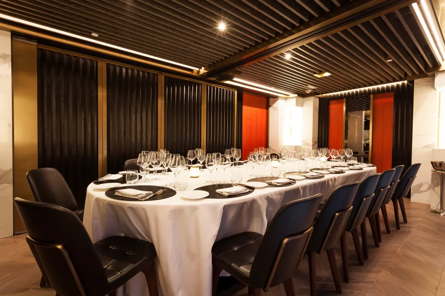 Elegant dining room interior at Beefbar Hong Kong, featuring a long table setting.