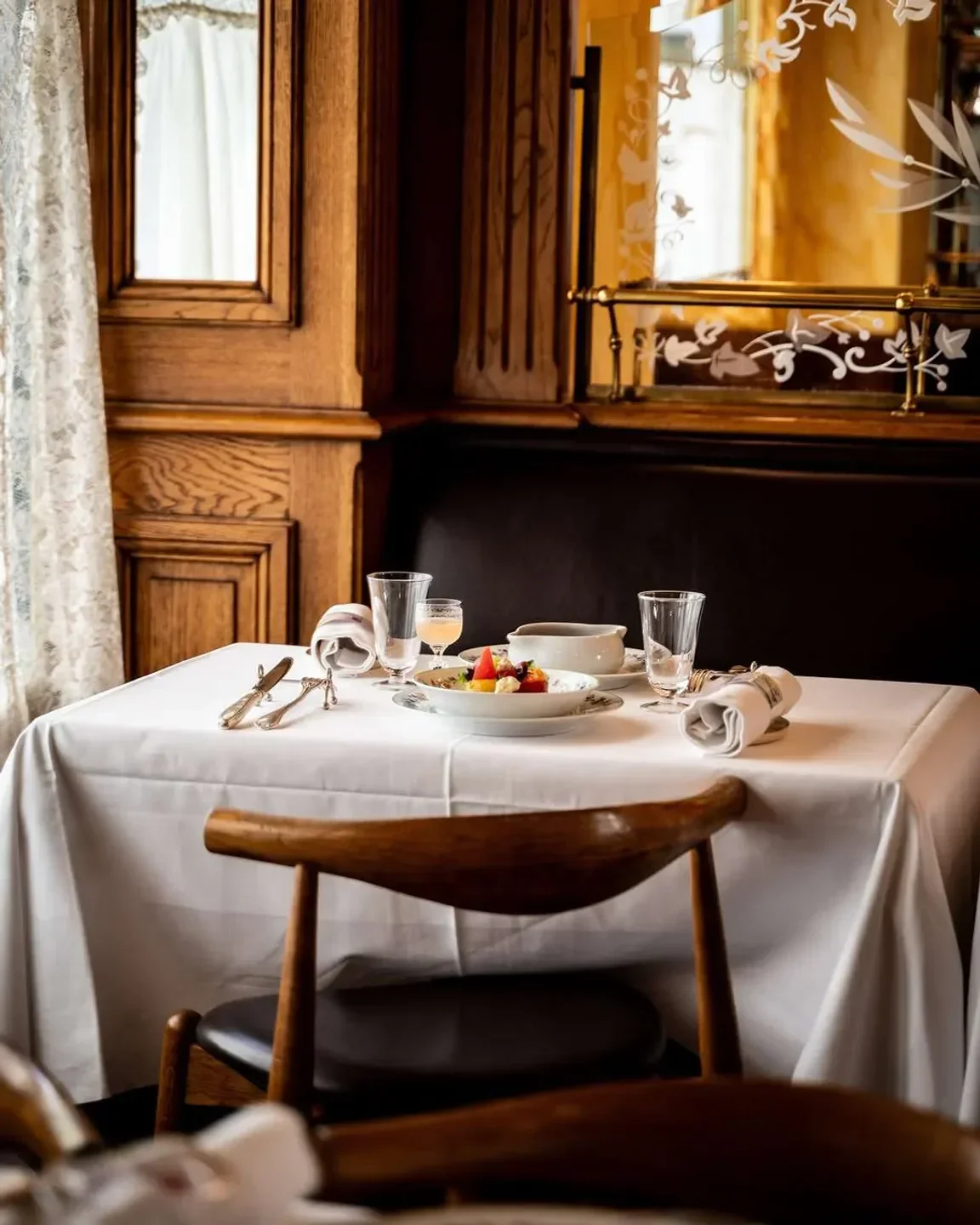 Elegant dining table at Benoit restaurant in Paris, ready for a meal.