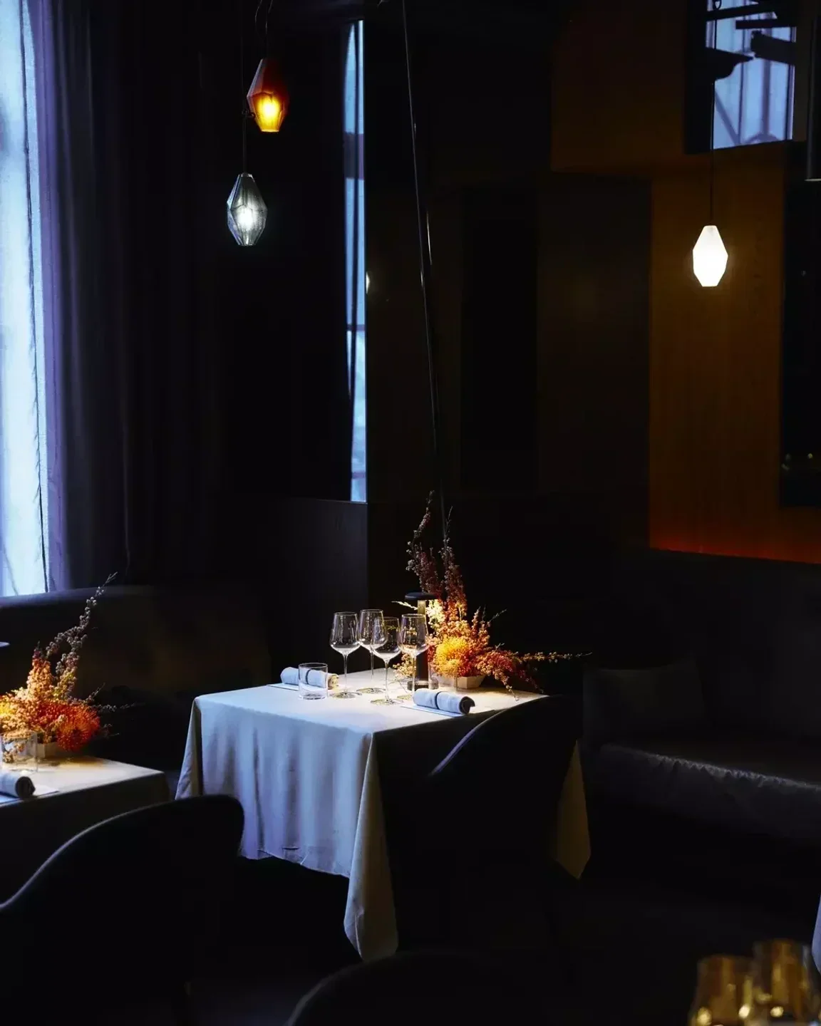 Elegant dining scene at Bentley Restaurant in Sydney, featuring table setting and moody lighting