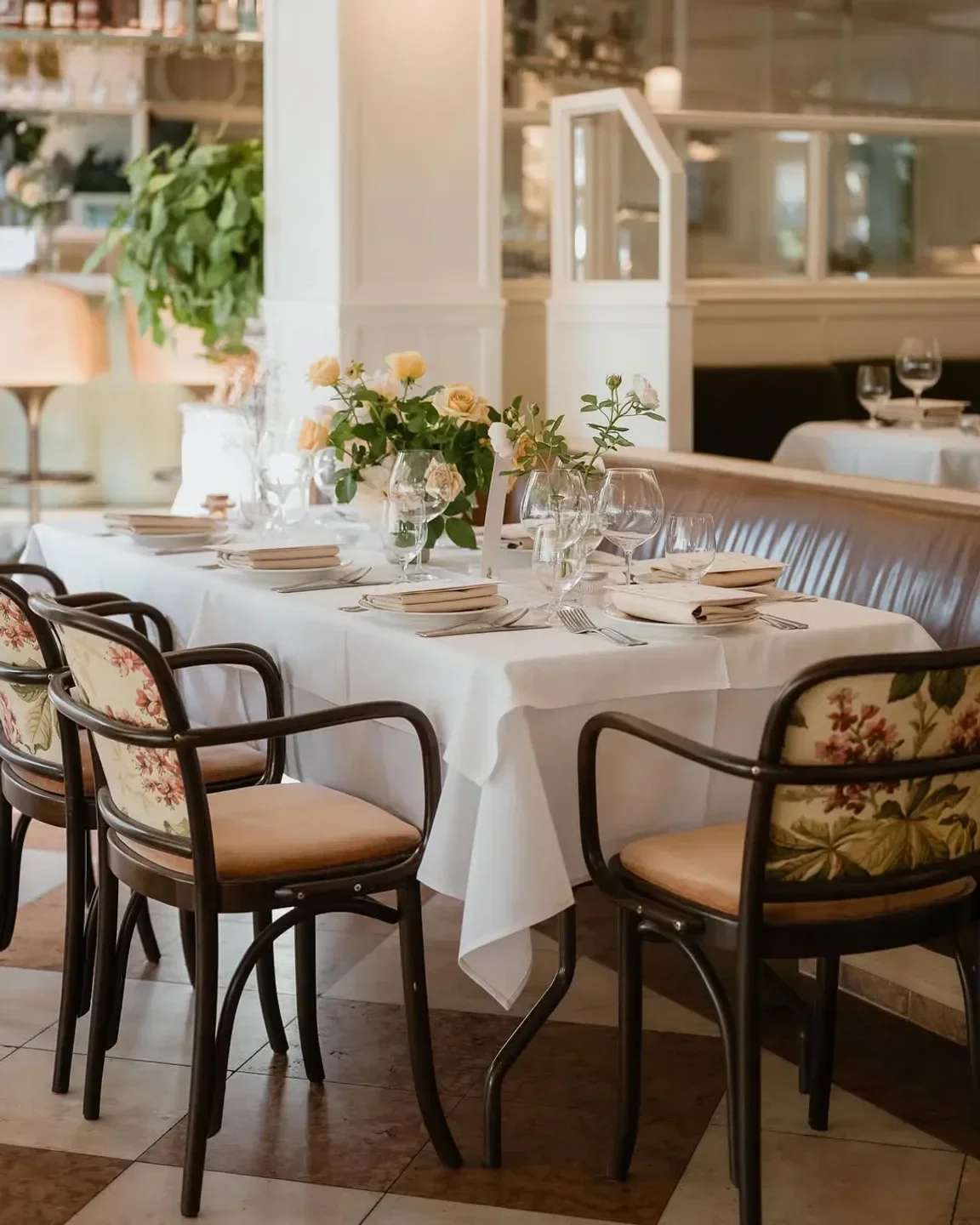 Elegant dining at Bert's Bar and Brasserie, Sydney, with floral chairs and table setting.