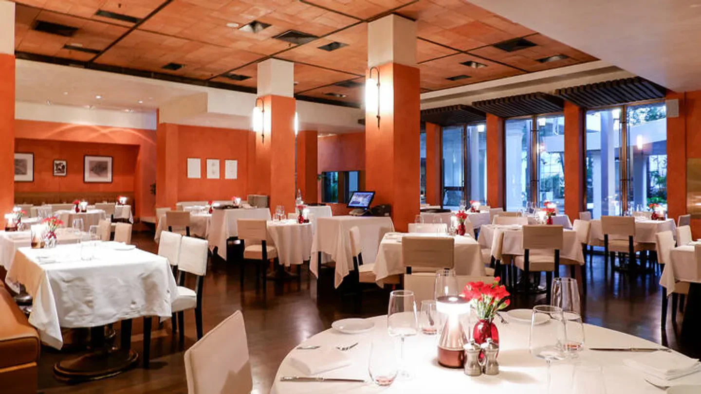 Elegant interior of Biscotti restaurant in Bangkok with tables set for dining