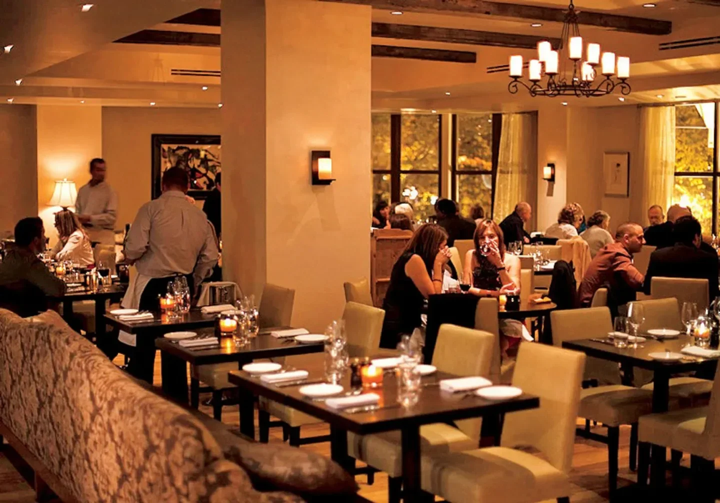 Bistro du Midi, Boston. Interior dining scene with guests enjoying a meal at the restaurant.