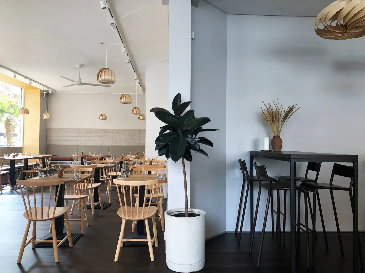 Interior of Bistro Lupa in Copenhagen: stylish dining area with wooden furniture.