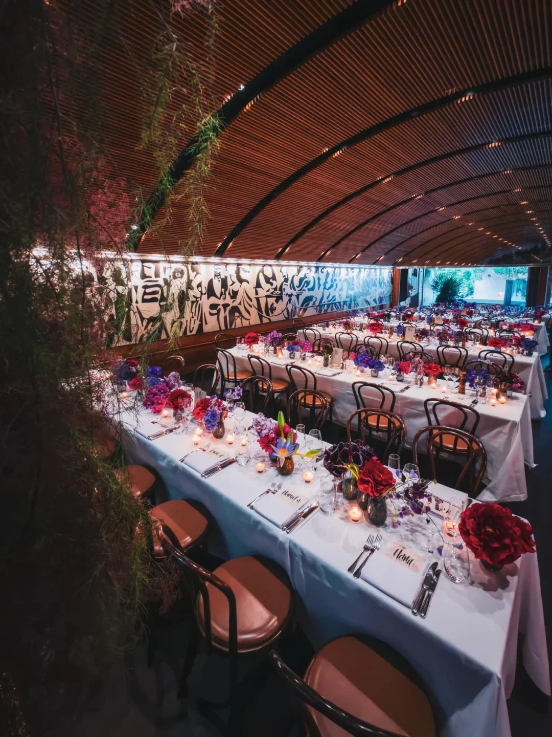 Elegant dining at Bistro Moncur in Sydney, tables set with flowers and candles.