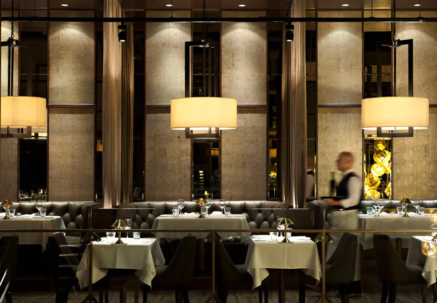 Elegant interior of Black Blue restaurant in Vancouver with tables set for service