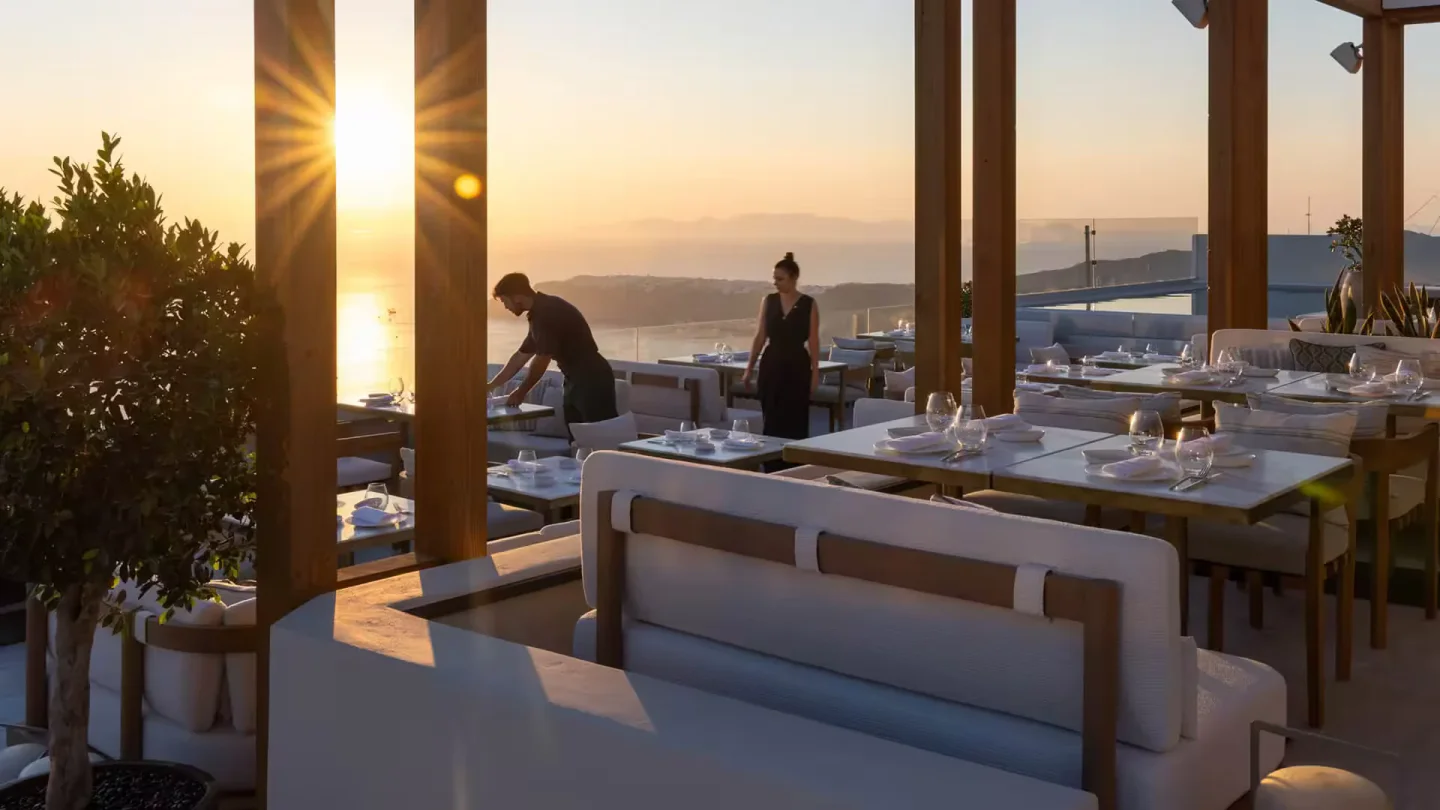 Blu restaurant Santorini outdoor dining area with tables set for dinner at sunset overlooking the sea
