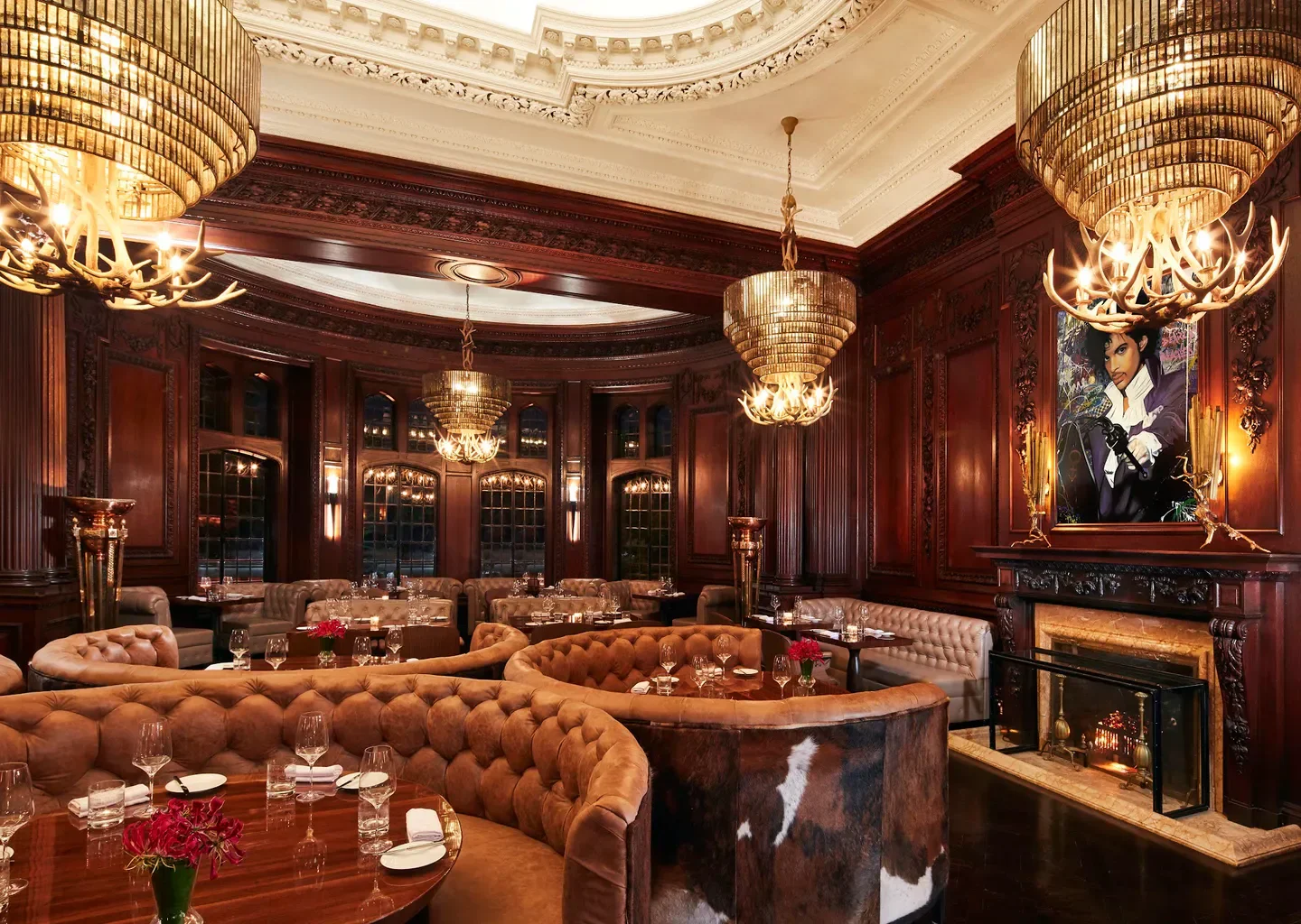 Elegant dining room at BlueBlood Steakhouse in Toronto with opulent chandeliers.