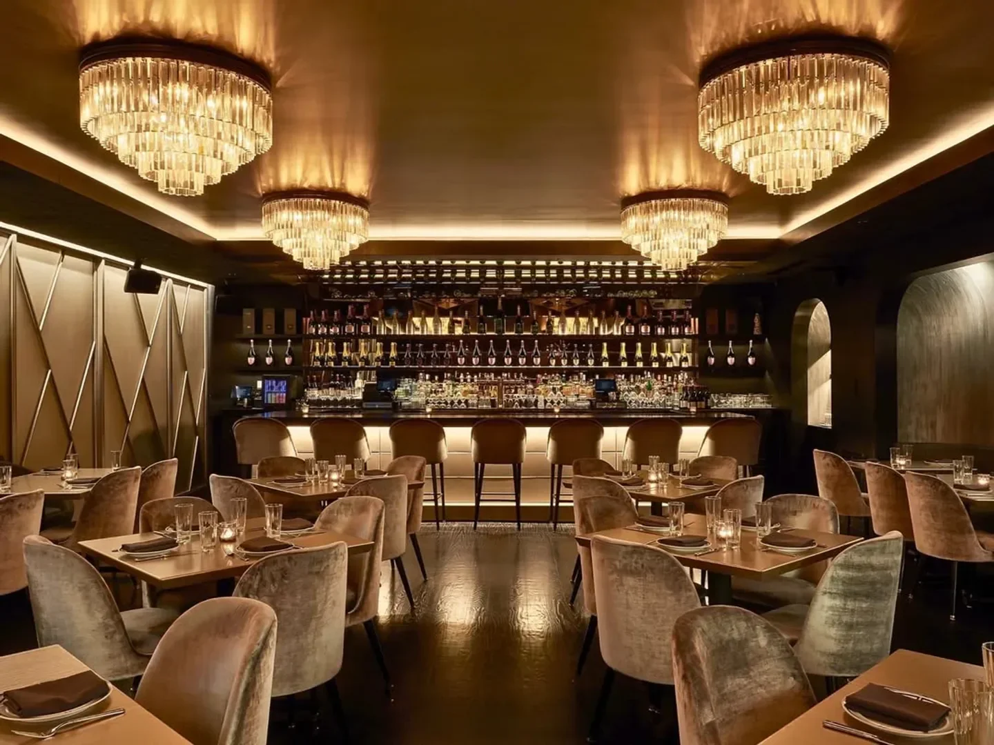 BLVD Steakhouse in Chicago: Elegant interior with chandeliers and bar seating.