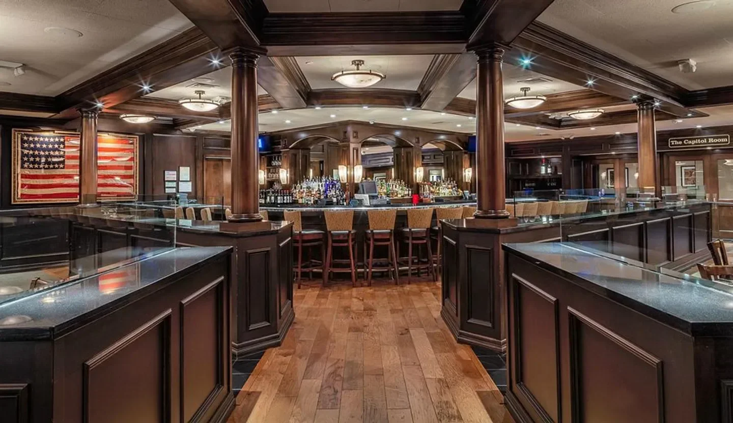Interior of Bob's Steak & Chop House - Austin, featuring bar and American flag decor in Austin.