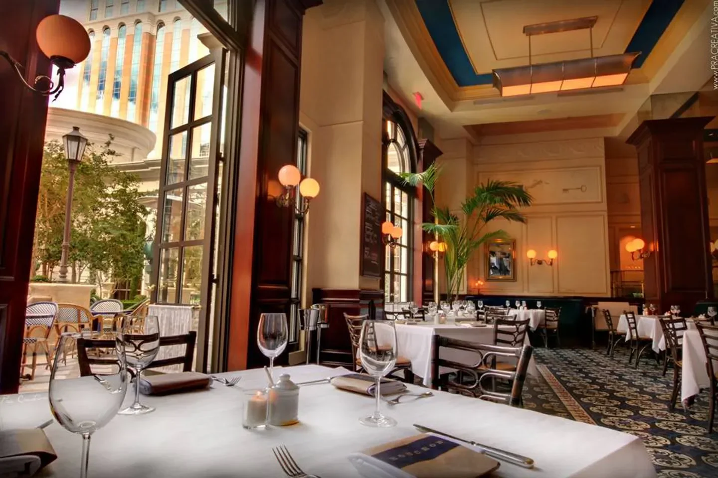 Elegant dining room at Bouchon restaurant in Las Vegas, with a view of the patio