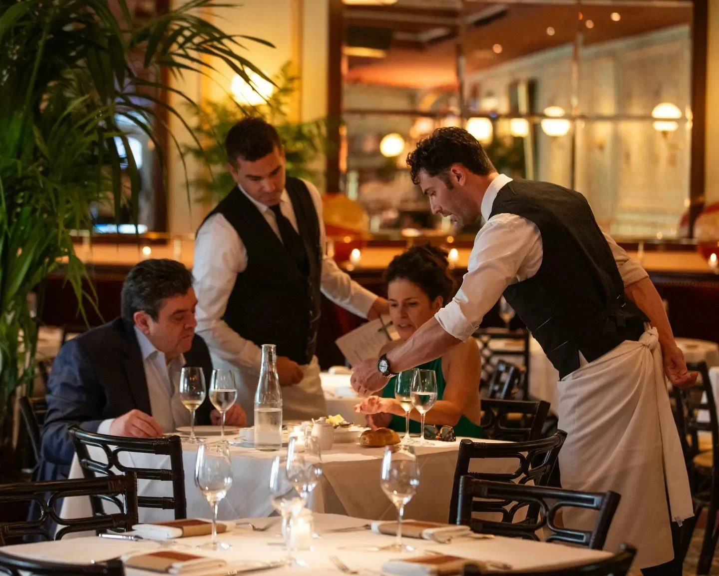 Bouchon Las Vegas, server attending customers at a table in a luxurious restaurant