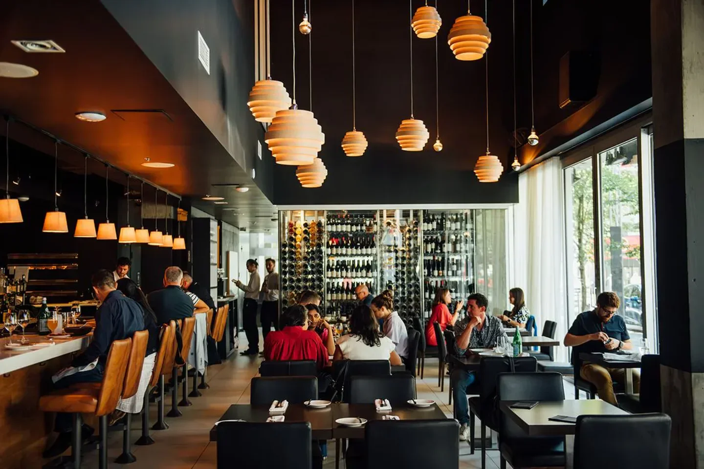 Interior of Bouillon Bilk restaurant in Montreal, featuring modern lighting and dining area.