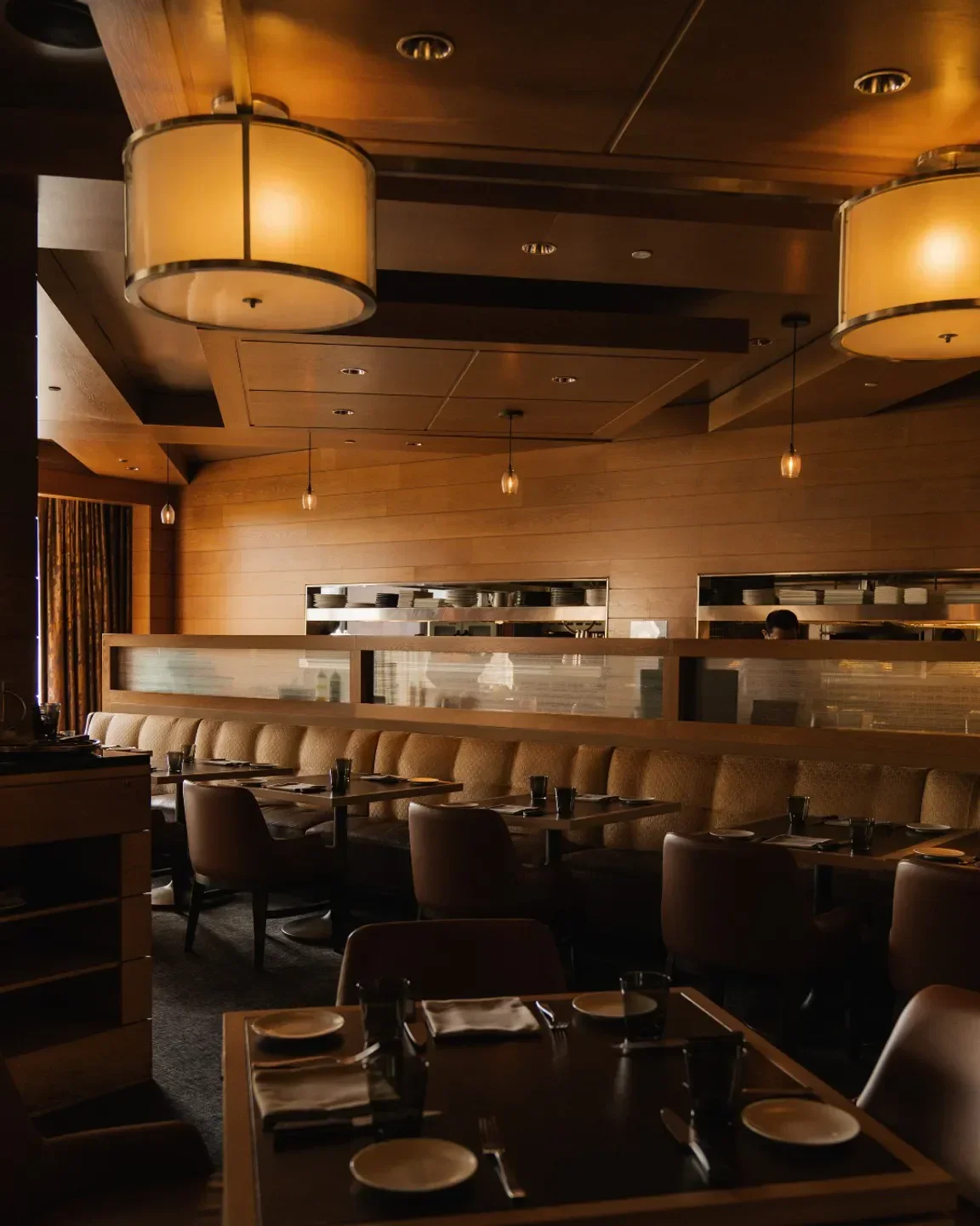 Cozy dining area at Bourbon Steak DC, a Washington restaurant with modern decor and lighting.