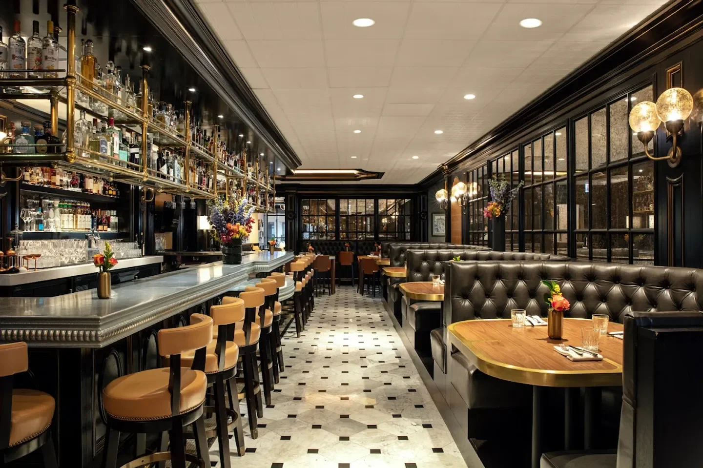 Interior of Brass Tack restaurant in Chicago, with bar and booth seating.
