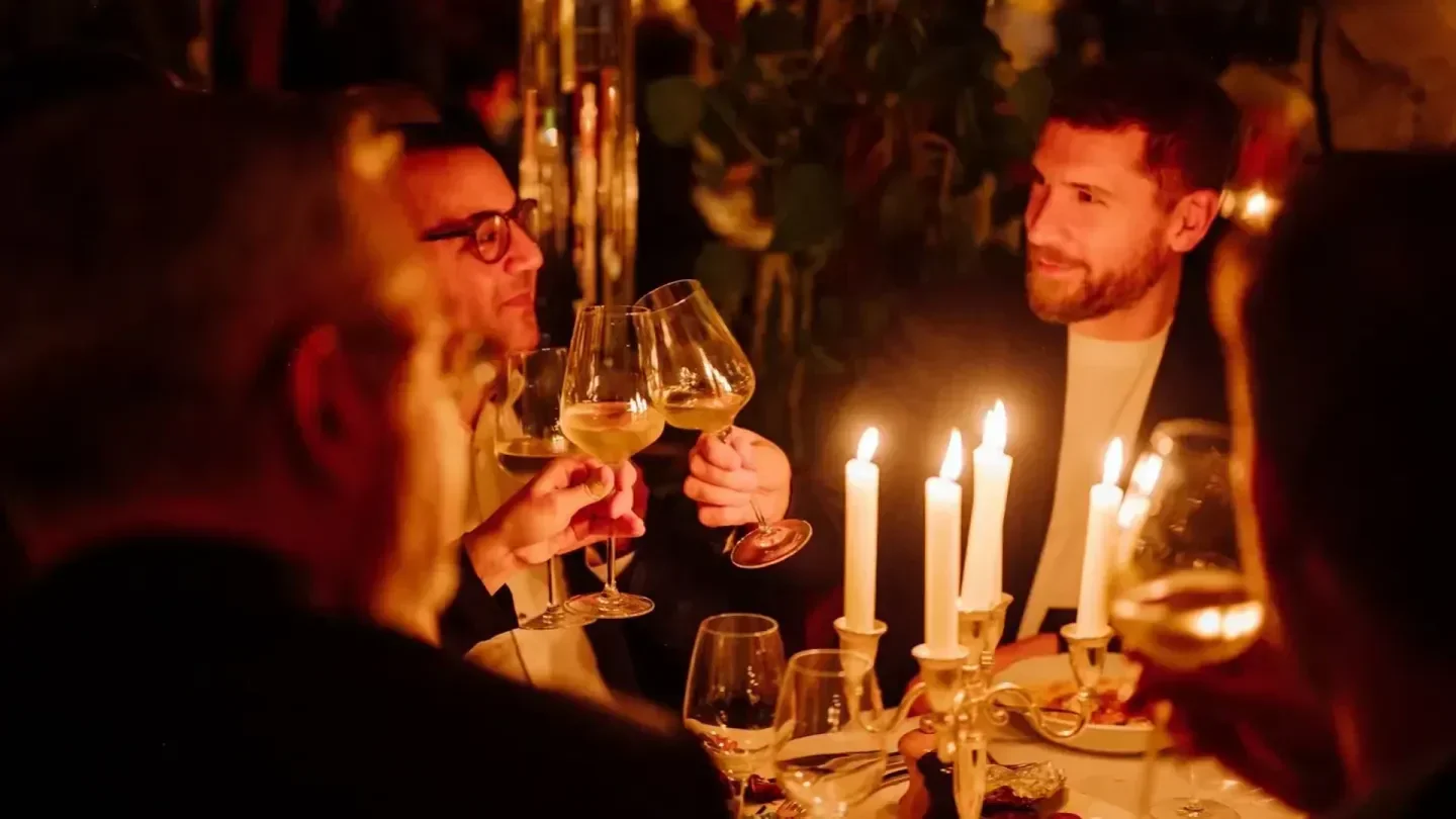 Cheers at Brasserie Thoumieux in Paris, elegant dining with candlelight and wine.