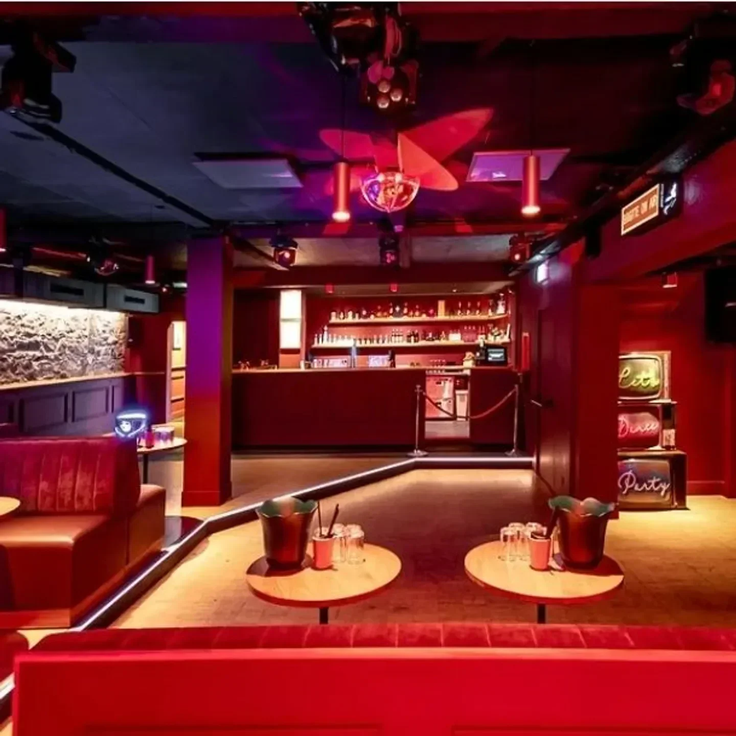 Interior of Brigitte Club in Geneva, with red decor and disco ball ready for a party.