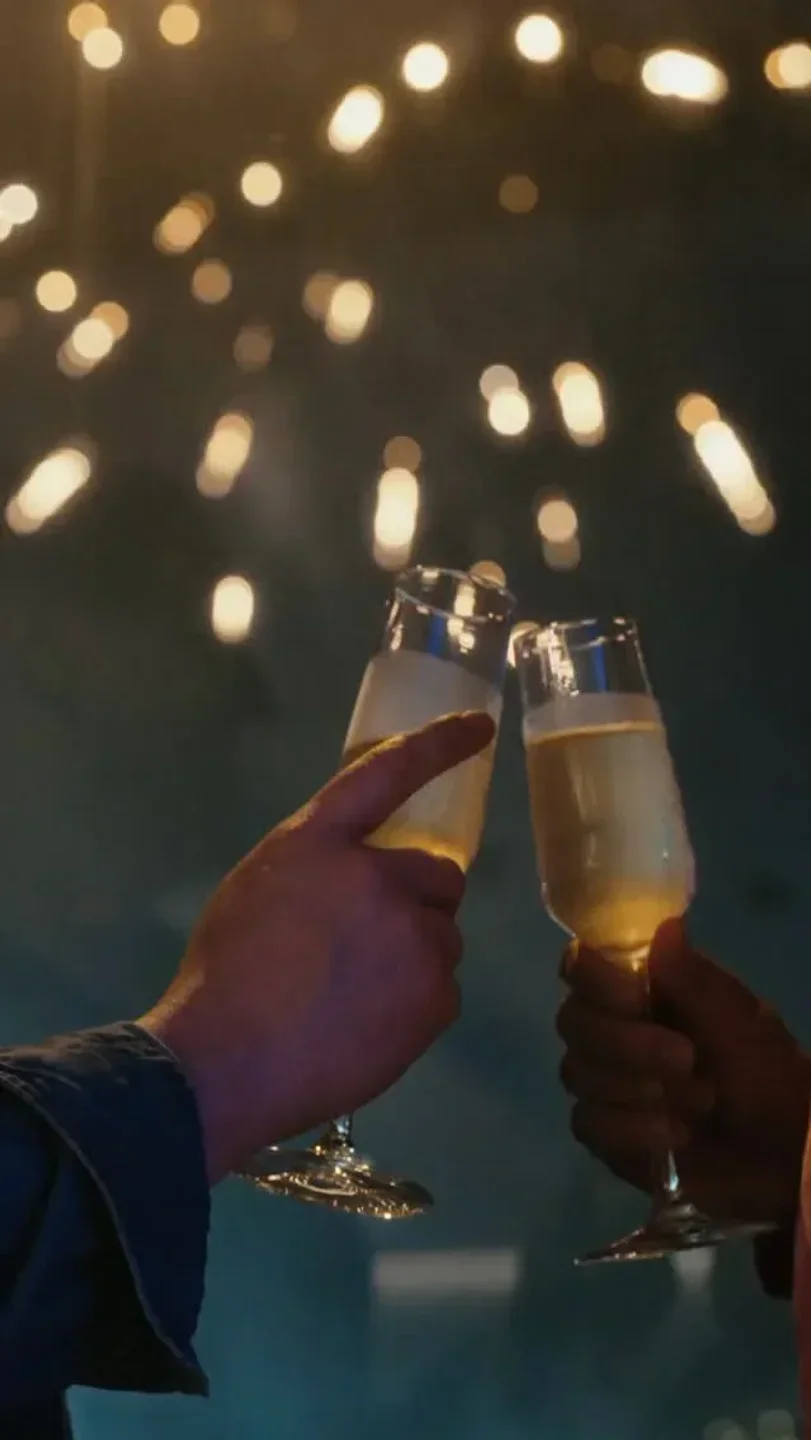 Cheers at BTWN restaurant in Sydney, celebrating with champagne under warm lights.