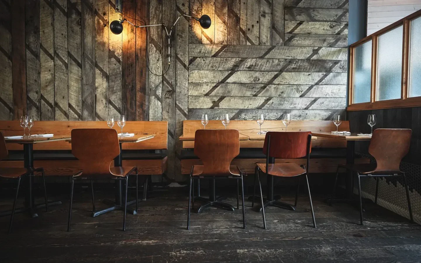 Interior of Burdock & Co restaurant in Vancouver, featuring rustic wood decor and seating