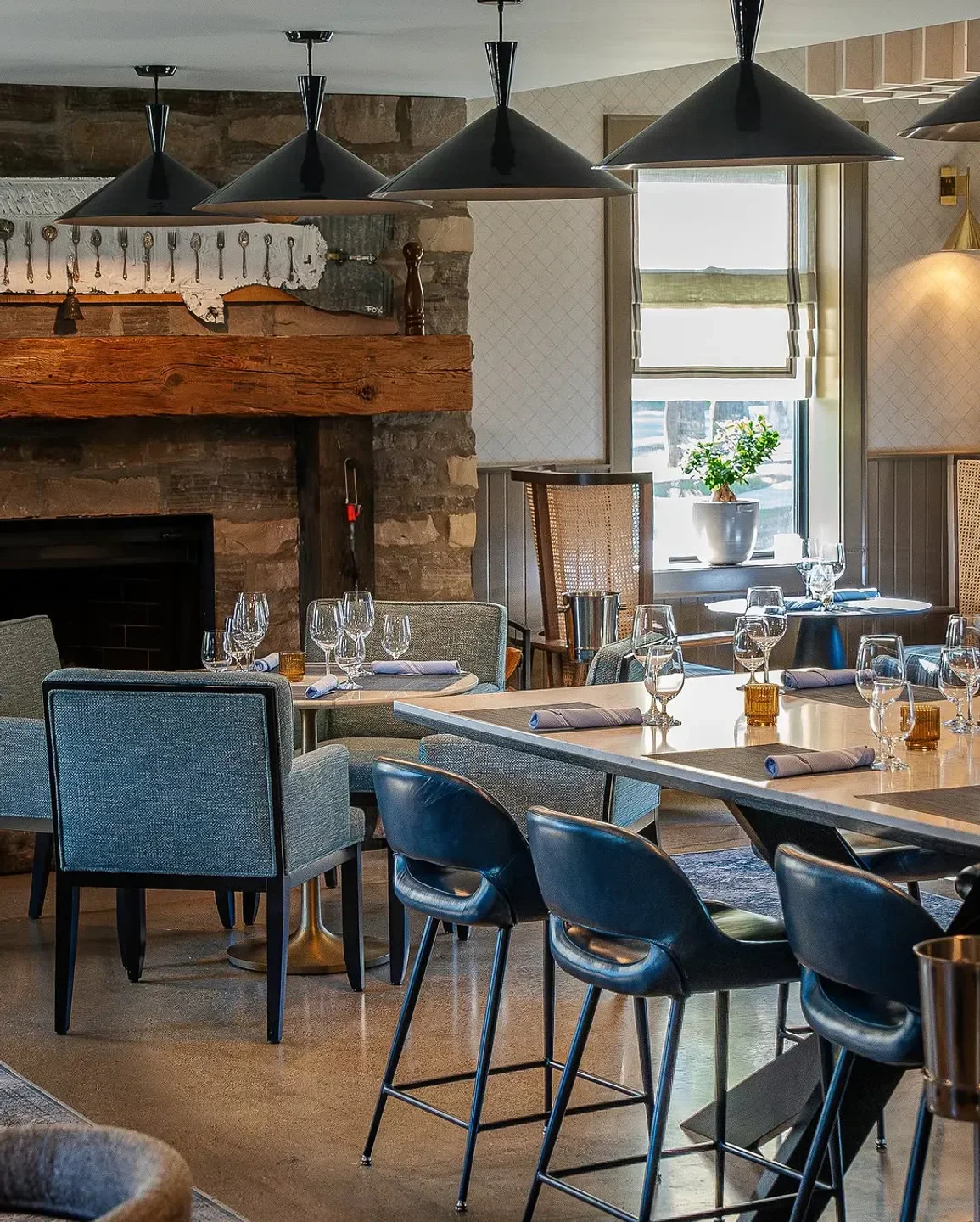 Cozy dining area at Bymark restaurant in Toronto, featuring a fireplace and stylish decor.