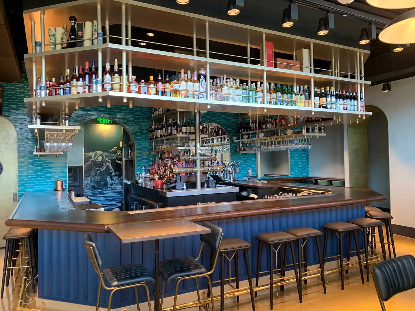 Interior bar at c Restaurant in Boston, with a diver mural and stylish design.