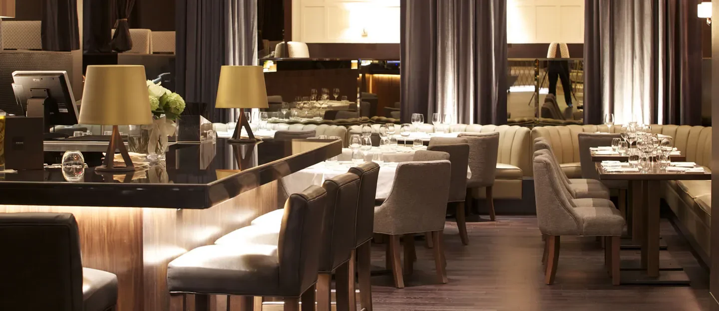 Interior of C-PRIME Modern Italian Steak and Wine in Vancouver with elegant decor and tables.