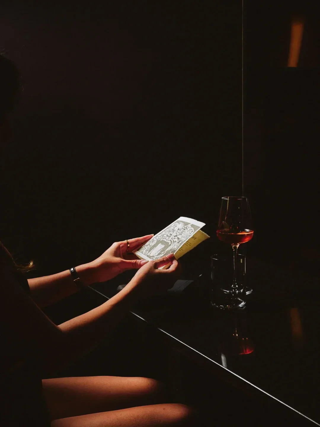 Reading at Cabaret L'enfer in Montreal, with a glass of wine and artistic atmosphere.