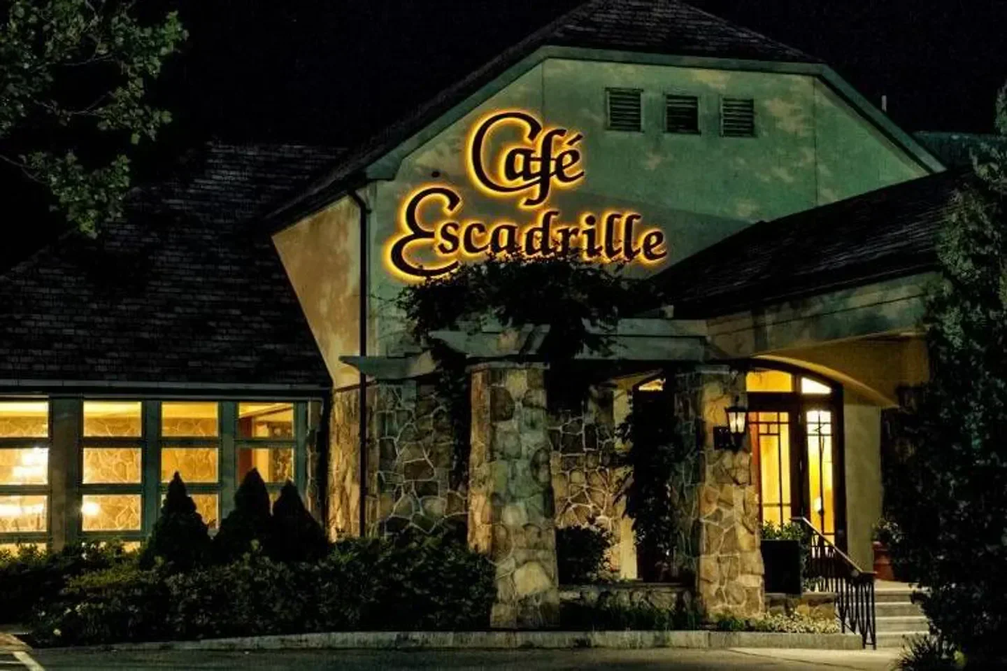 Cafe Escadrille restaurant in Boston at night, illuminated sign and entrance.