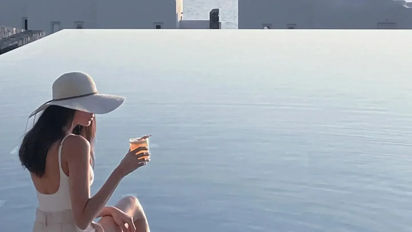 Enjoying a drink by the infinity pool at Canaves in Santorini, Greece.