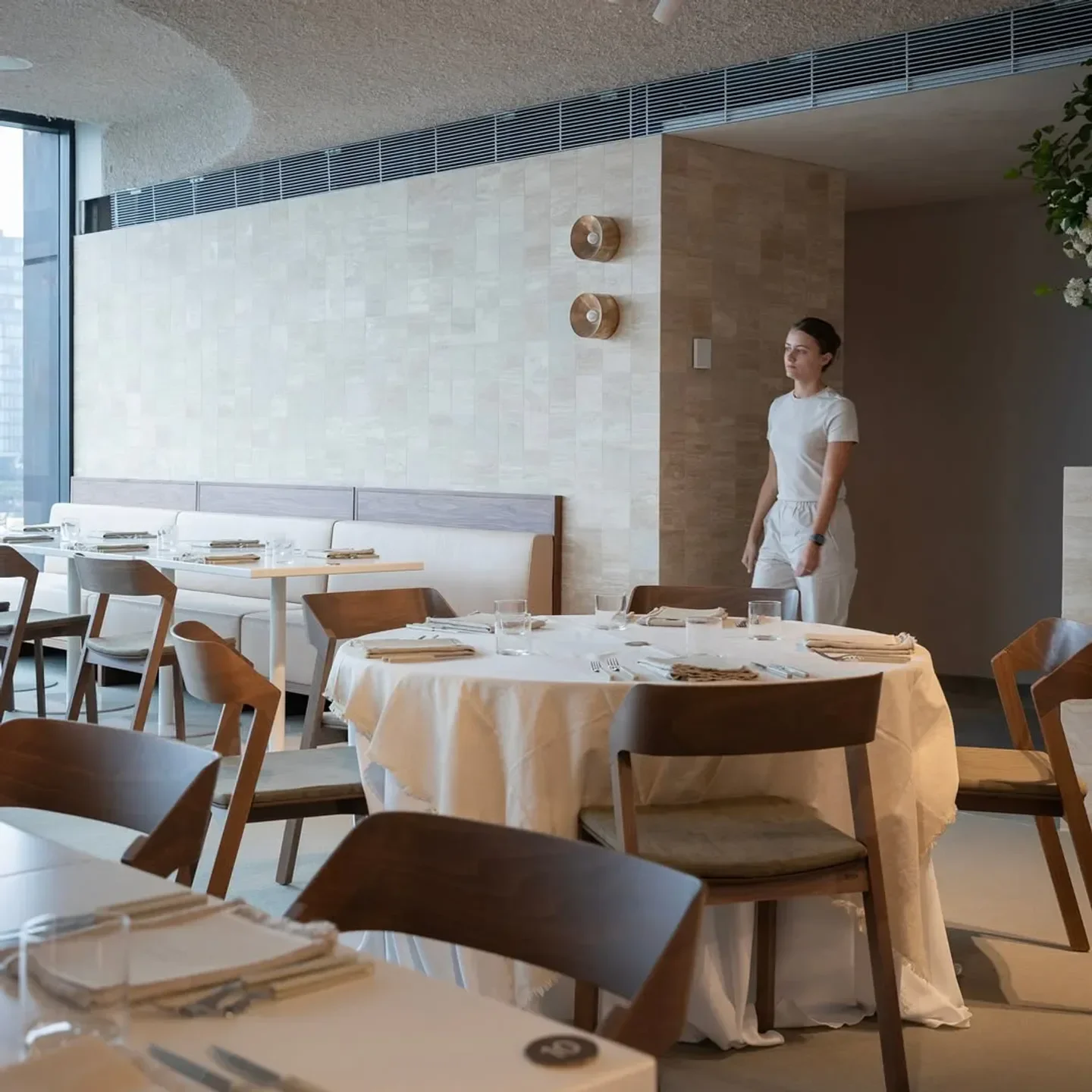 Interior of CANVAS restaurant in Sydney, featuring elegant tables and chairs with a guest.