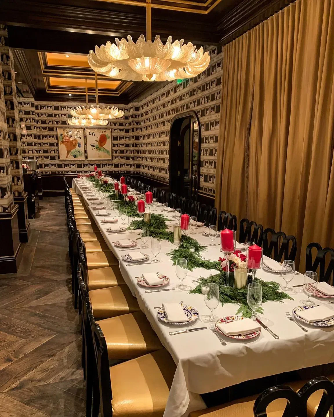 Elegant dining room at Carbone Las Vegas, with candles and festive table setting.
