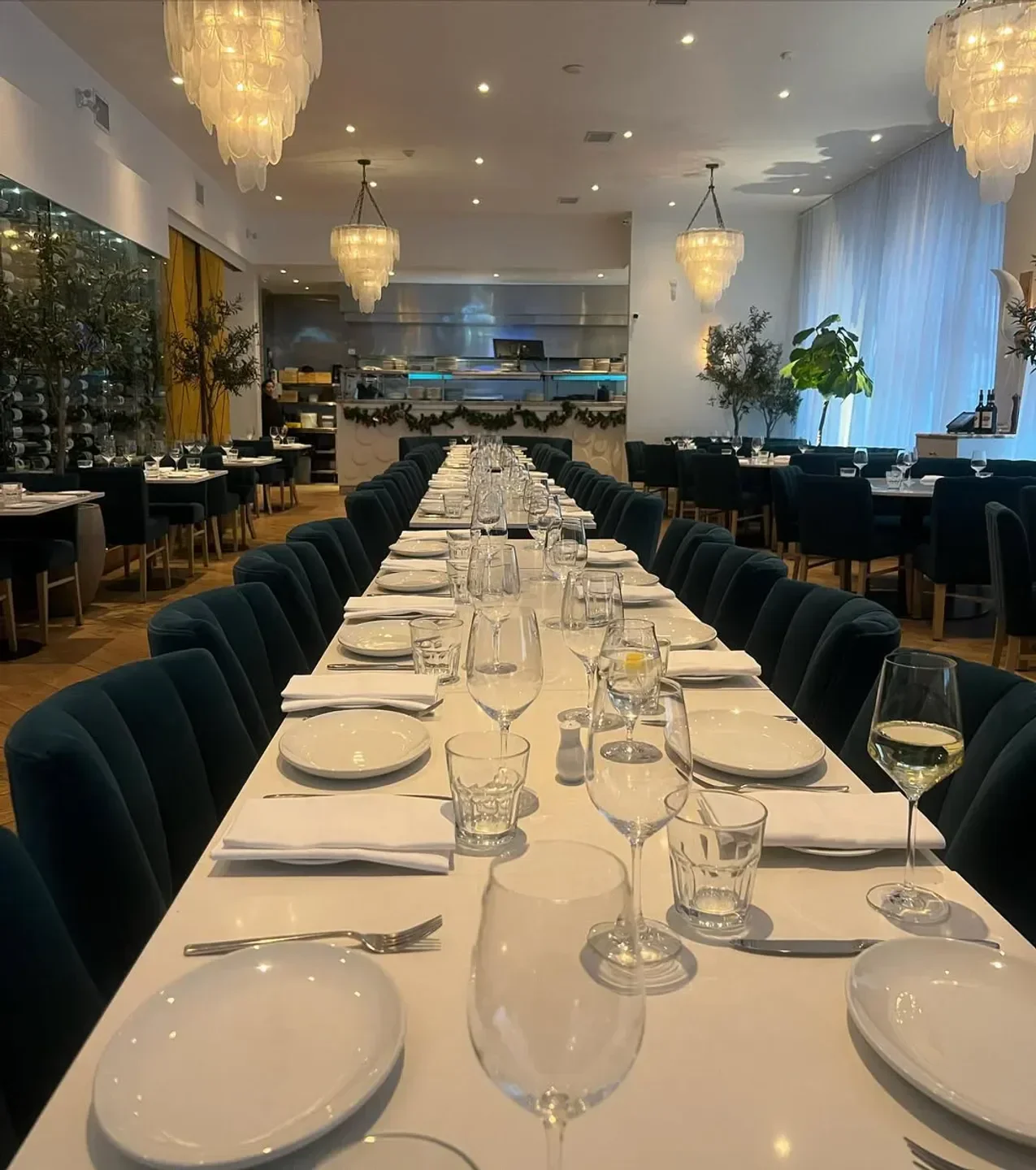 Elegant dining room at Carisma in Toronto, featuring a long table set for a special occasion.
