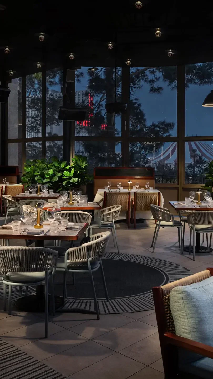 Carversteak Las Vegas dining room at dusk with elegant tables and outdoor views.