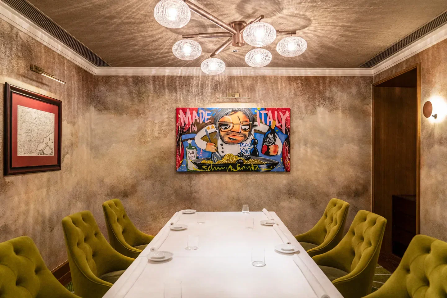 Cozy dining room at Castellana in Hong Kong with unique artwork and seating.