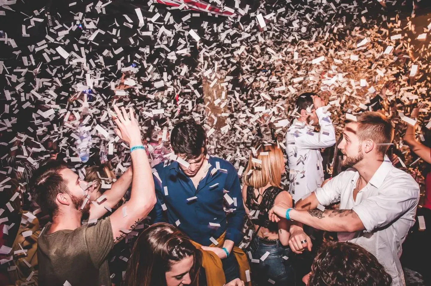 Confetti shower at Catwalk nightclub in Barcelona with a crowd partying.