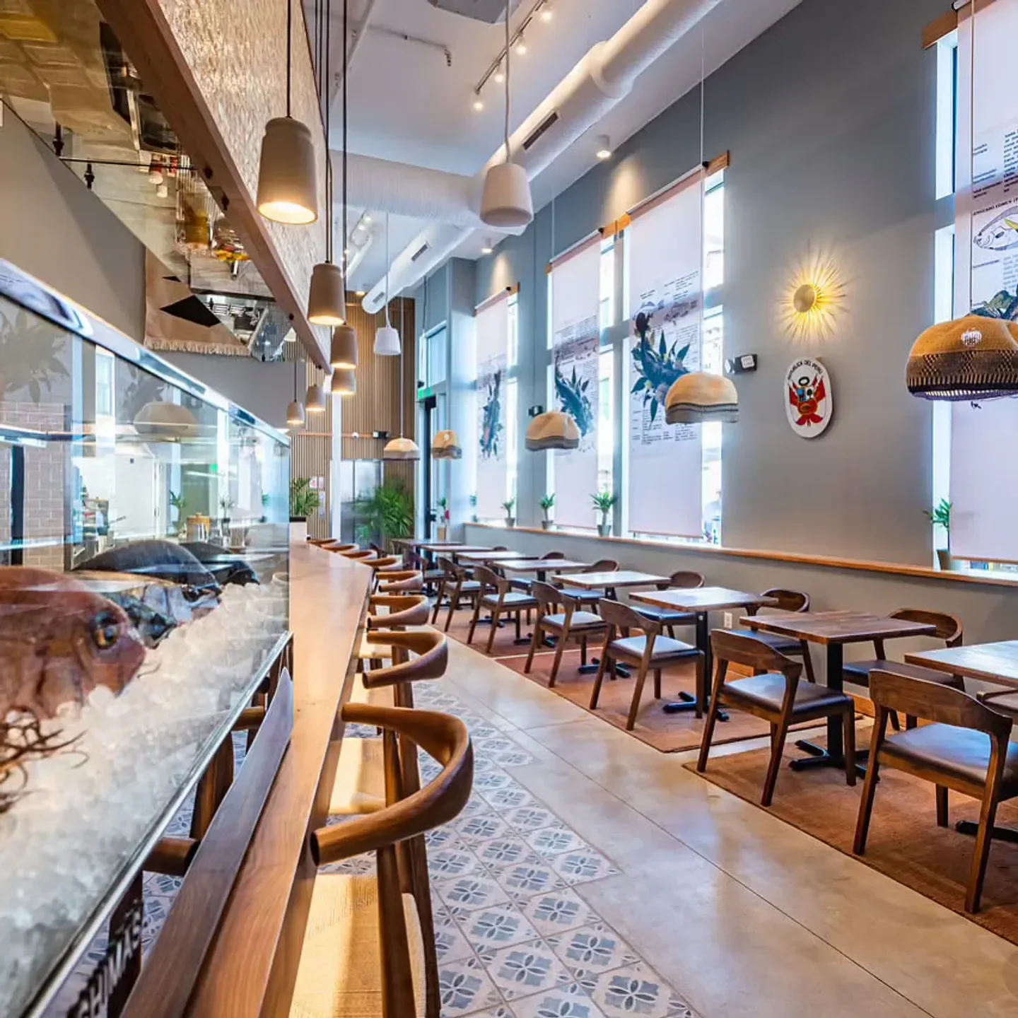 Interior of Causa restaurant in Washington, with fresh seafood on display and tables.