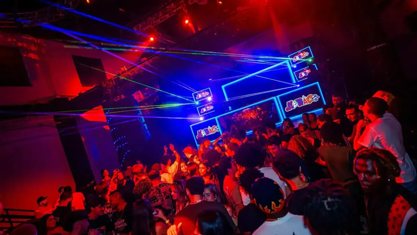 Energetic dance floor at Celine nightclub in Orlando, with laser lights and a crowd.