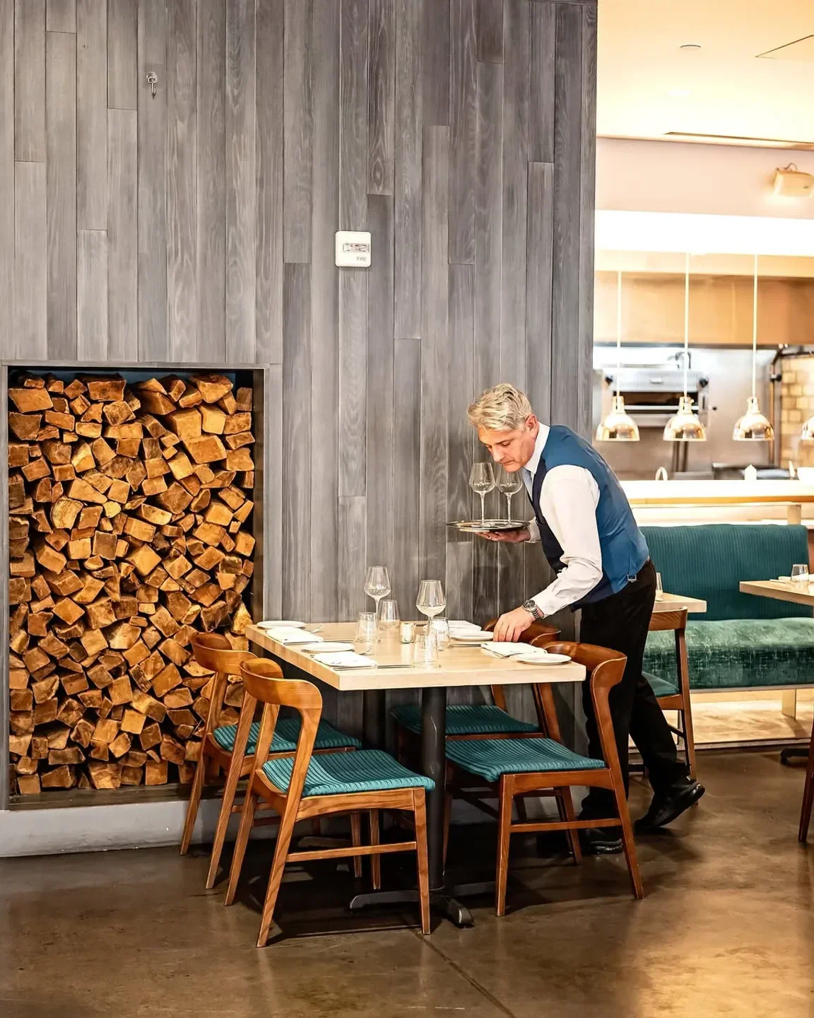 Centrolina restaurant in Washington: waiter sets table in stylish interior