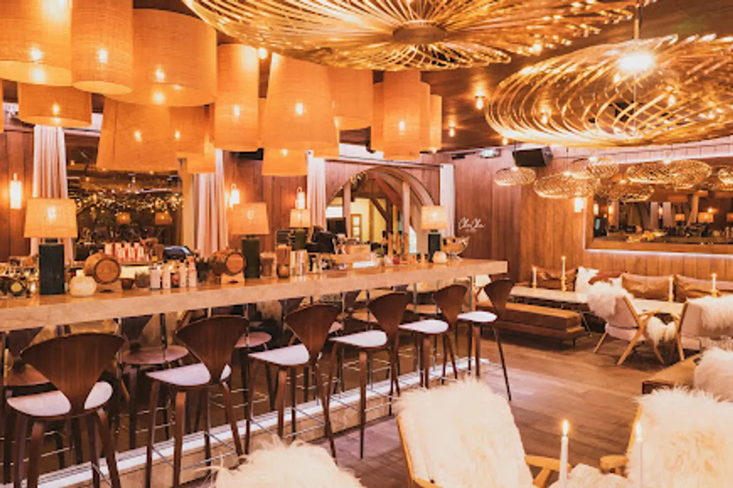 Cozy interior of ChaCha restaurant in Megeve, featuring stylish bar and lighting.