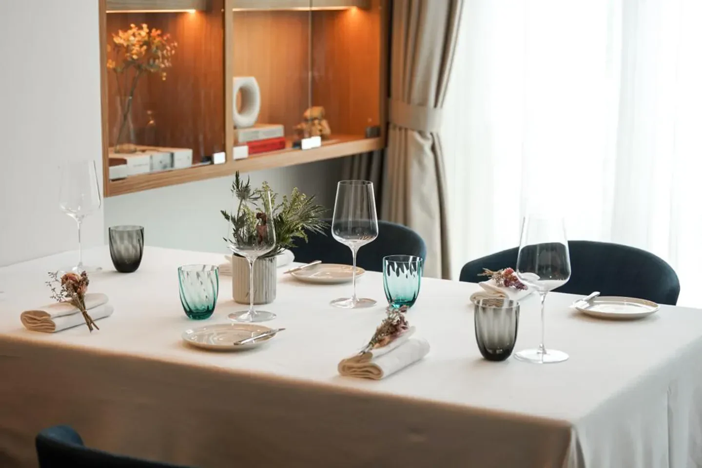 Elegant table setting at Chaleur restaurant in Singapore, featuring fine glassware and decor.