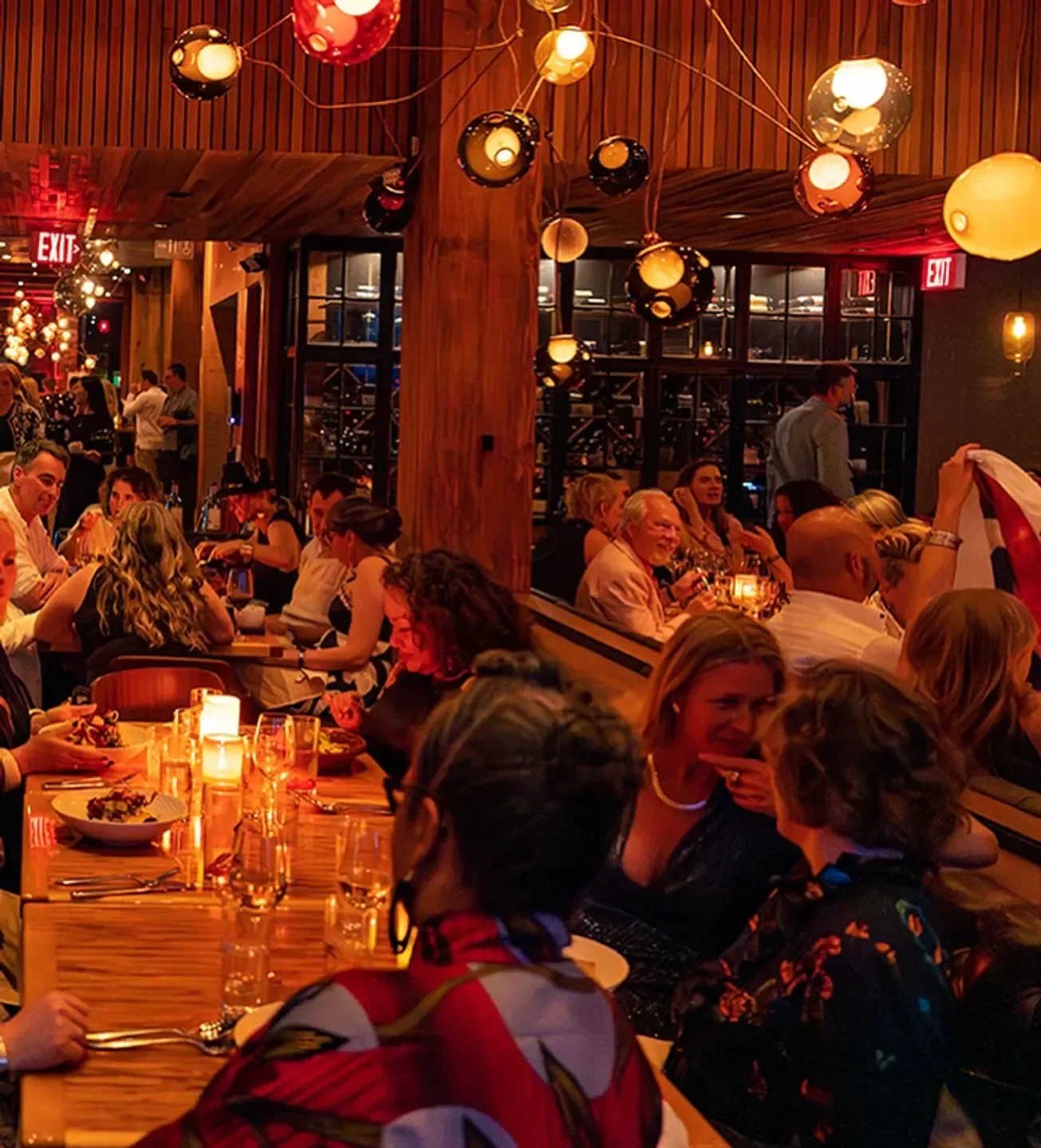 Interior dining at Chambar Restaurant in Vancouver with warm lighting and people gathered