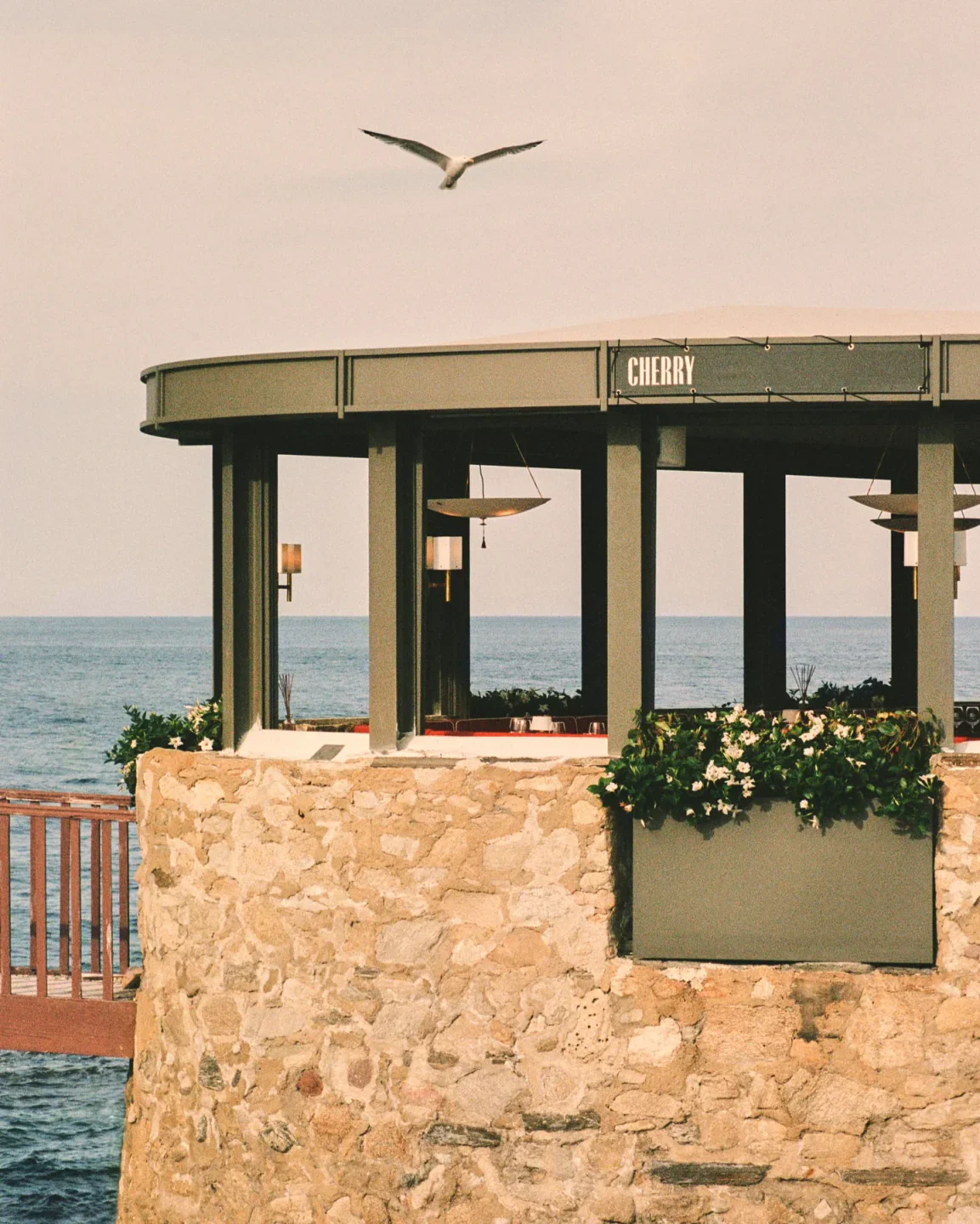 Cherry St. Tropez restaurant exterior with stone walls and ocean view in Saint-Tropez.