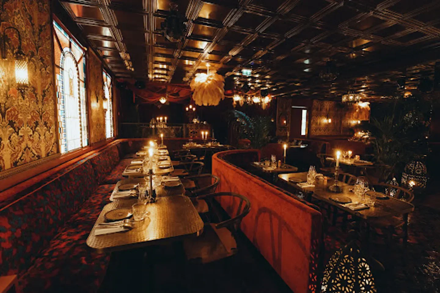 Cozy dining room at Chez Gala in Paris, with candles and elegant decor.