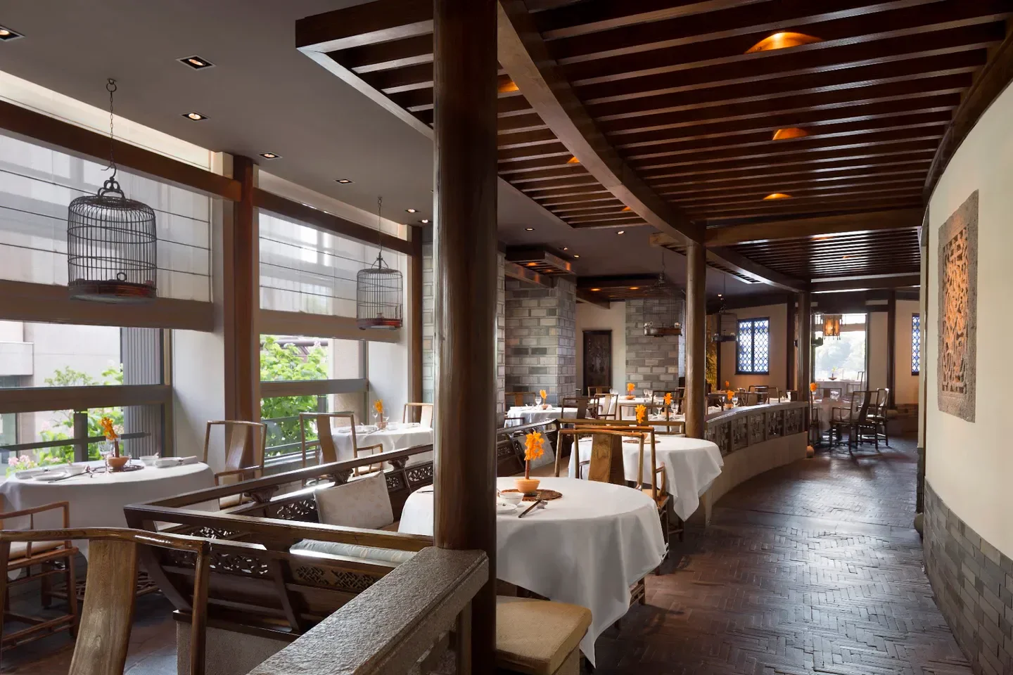 Elegant dining room interior at Chinois restaurant in Tokyo, featuring birdcage decor.