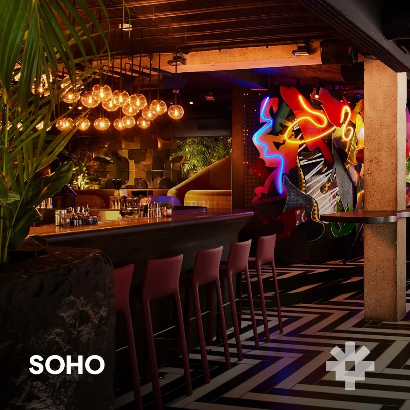 Chotto Matte London restaurant interior featuring a vibrant neon art wall and stylish bar.