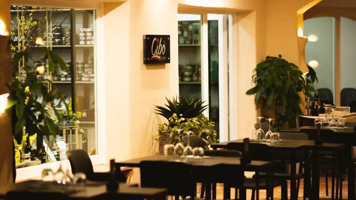 Interior of Cibo restaurant in Porto Cervo, featuring tables and a stylish decor.