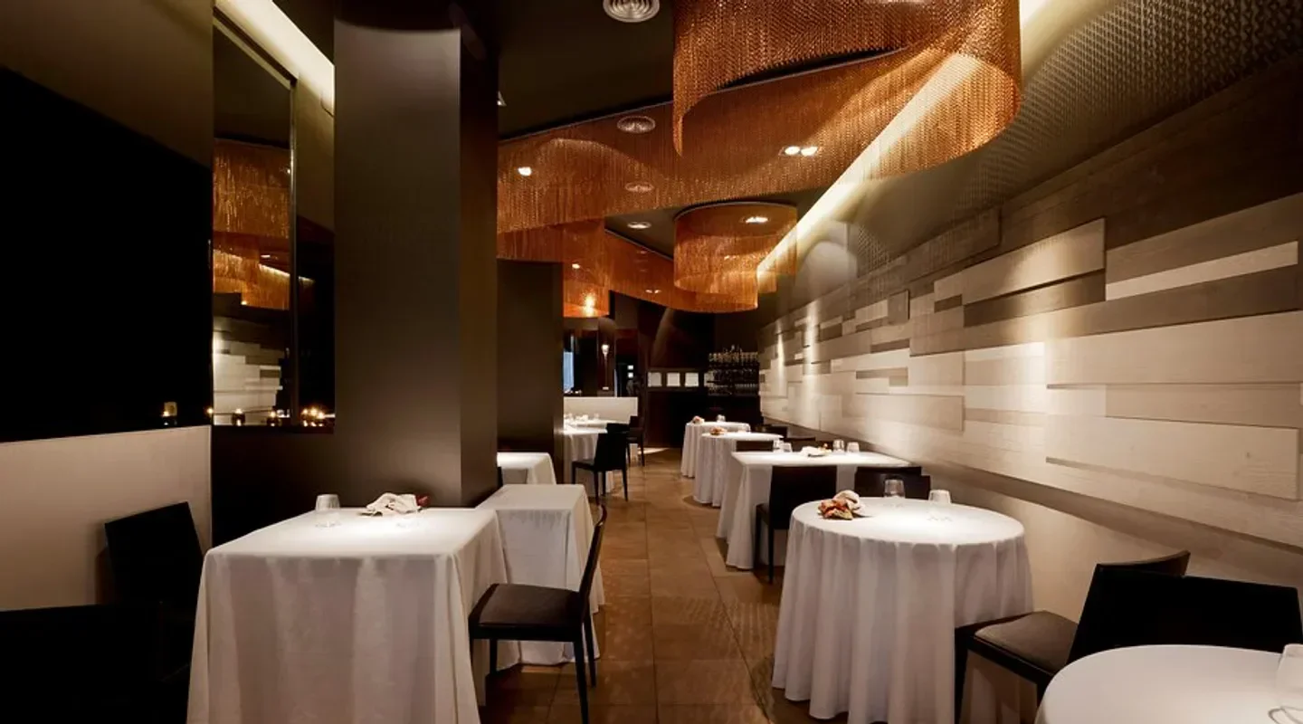 Elegant dining room interior at Cinc Sentits restaurant in Barcelona, with stylish decor.